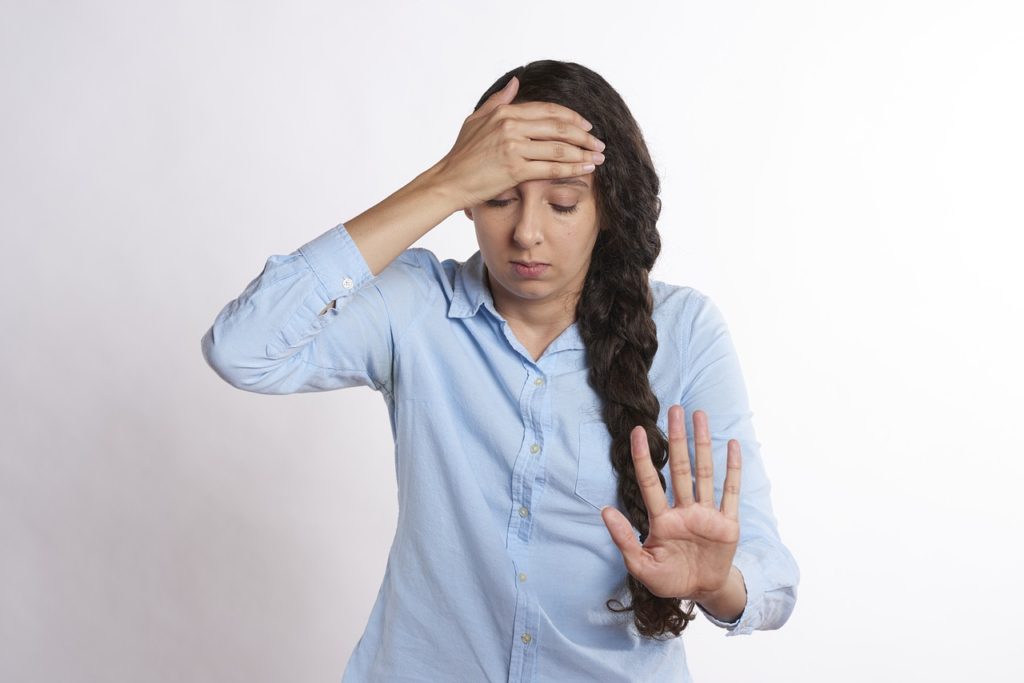 upset woman putting her hand on her head, 14 excuses to avoid sex, headaches, annoyedmama.com